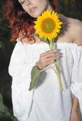 Beautiful woman in meadow with sunflowers.