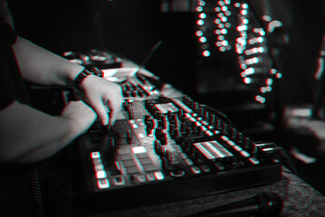 male DJ mixes electronic music on a professional music controller