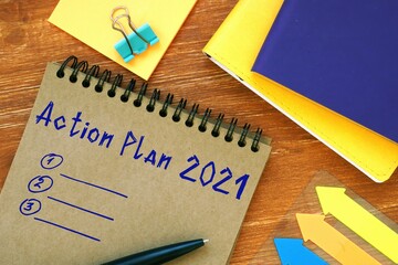 Financial concept meaning Action Plan 2021 with phrase on the piece of paper.