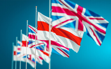 Waving flags of Belarus and United Kingdom waving against blue background. Politics relation between countries. White-red-white new protest flag.