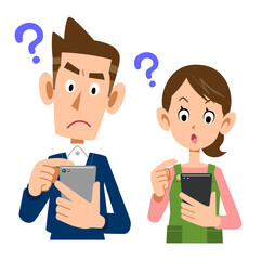 疑問の表情でスマートフォンを操作する若い夫婦

