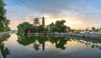 Fototapeta na wymiar Tran Quoc pagoda during sunset time, the oldest temple in Hanoi, Vietnam. Hanoi cityscape.