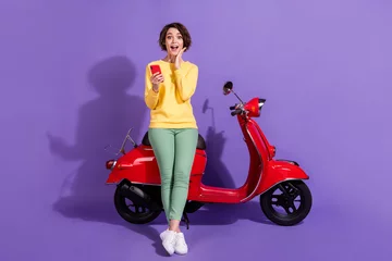 Foto op Plexiglas Full length body size view attractive amazed stunned cheerful glad girl sitting on bike using device browsing post app 5g isolated over bright vivid shine vibrant lilac violet purple color background © deagreez