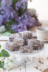 Chocolate & coconut cake with lilac flowers