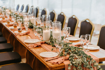 Beautiful wedding table setting decorated with flowers and candles
