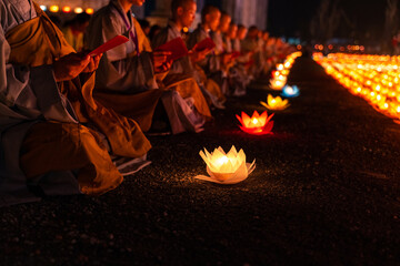 Monks praying at night on Vesak day for celebrating Buddha's birthday in Eastern culture