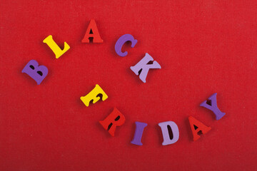 BLACK FRIDAY word on red background composed from colorful abc alphabet block wooden letters, copy space for ad text. Learning english concept.