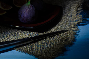 Still life with figs on the wooden background