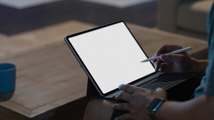 A man using mock up tablet with stylus and keyboard on his lap