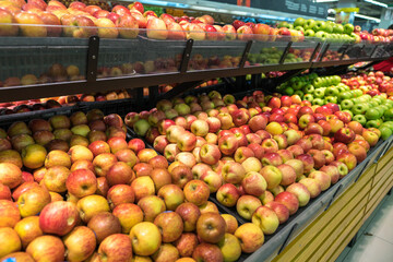 Fresh healthy fruits on shelves in supermarket