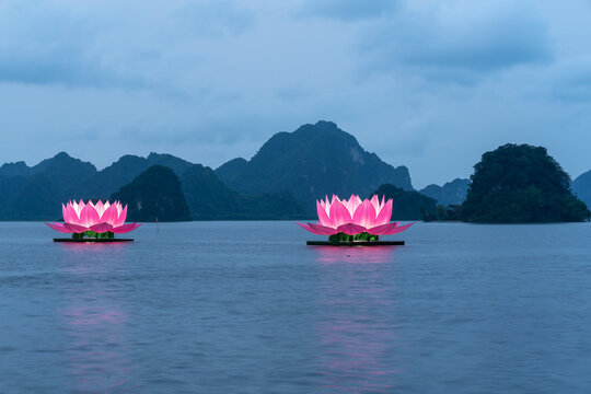 Floating illuminated lotus lanterns on lake during Buhha festival in Vietnam