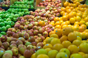 Fresh healthy fruits on shelves in supermarket