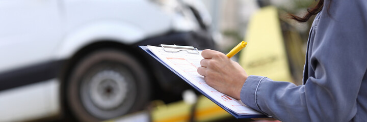 Insurance agent fills out paperwork after accident. Third party liability insurance for vehicle...