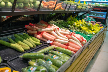 Fresh tropical vegetable on shelves in modern supermarket