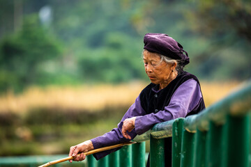 Old woman in Vietnam is fishing in a River
