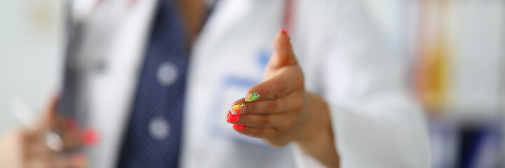 Woman doctor in background stretches out her hand. Trust between doctor and patient concept