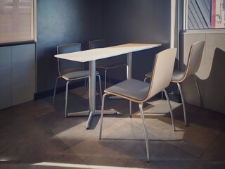 Chairs and table in the empty restaurant.The sun shines into the dining room. Sunlight hits objects