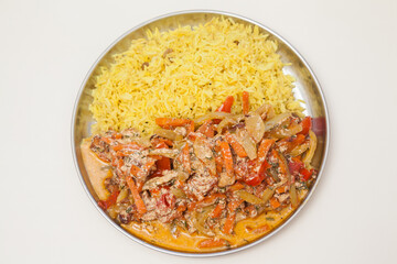 Plate with basmati rice and vegetables on white background