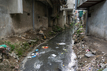 Dirty polluted waste water in big city with garbages. Environment pollution. Urban environment...