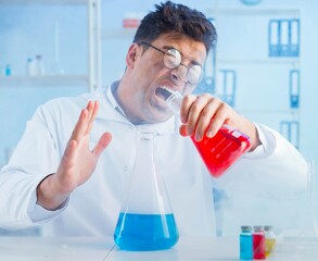 Funny mad chemist working in a laboratory