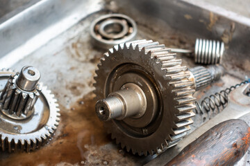 Old shiny motorcycle gears. Disassembly of the engine