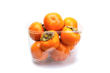 Persimmons in transparent plastic box