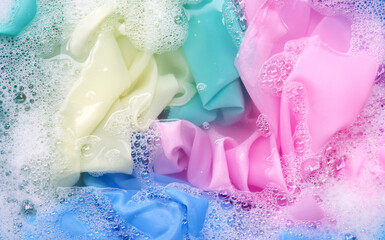 Color clothes soak in powder detergent water dissolution. Laundry concept