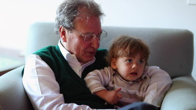 Grandfather And Grandson Watching TV Together