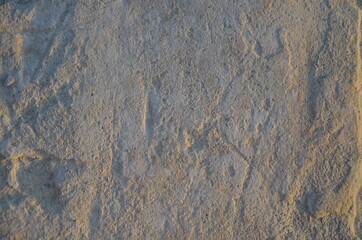 Details of sand stone texture, closeup shot of rock surface with vignette at cover and bright spot at centre, idea for background or backdrop.