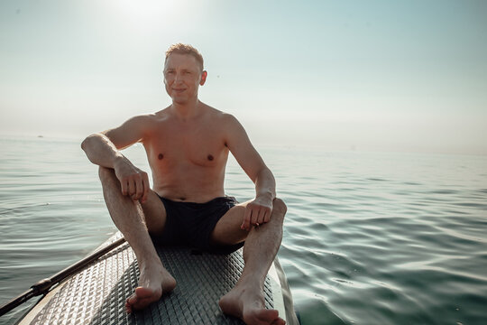 A man from the water, paddle boarding, SUP Board closeup