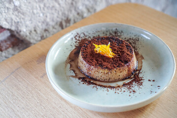 Espresso panna cotta. A caramel milk pudding topped with cocoa and espresso shot at cafe. (isolated)