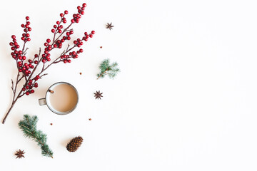Autumn composition. Cup of coffee, fir tree branches, berries on white background. Christmas, winter concept. Flat lay, top view