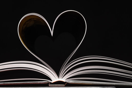 Open book with pages in the shape of a heart. Close-up.