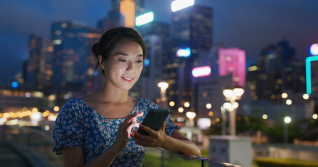 Woman use cellphone for online at night © leungchopan