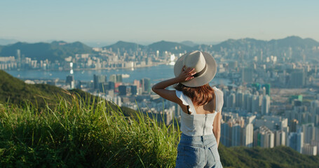 Fototapeta premium Woman look at the city view on mountain