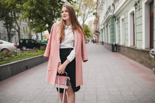 cute attractive stylish smiling woman walking city street in pink coat spring fashion trend, elegant style