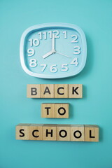 Back to School with clock on blue background