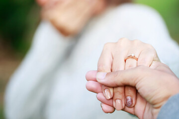 Women and man wear a ring in the finger holding hands together, Happy love in the garden. romantic atmosphere in the parks. concept couple lover valentine day. shake hands