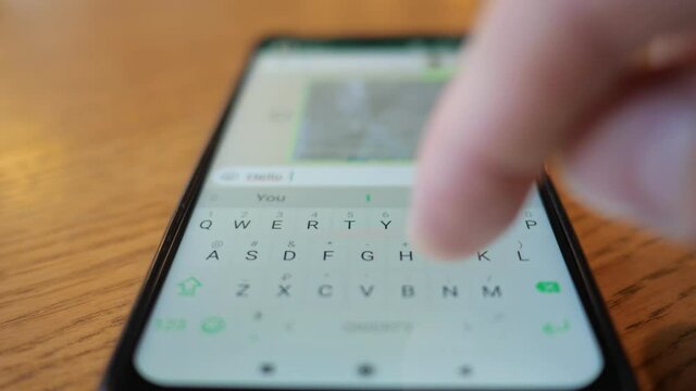 male hand typing a message on the phone.