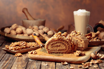 Walnut cake and coffee latte with cream on a wooden table.