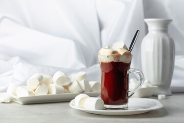 Hot chocolate with marshmallows in glass mug.