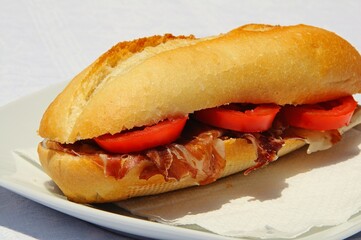Crusty roll with cured ham (Jamon Serrano) and tomato.