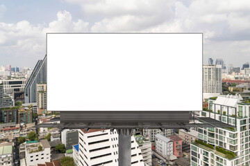 Blank white road billboard with Bangkok cityscape background at day time. Street advertising poster, mock up, 3D rendering. Front view. The concept of marketing communication to promote or sell idea.