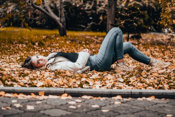 girl on the leaves in autumn
