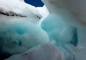 Blue ice inside a mountain glacier grotto. Alibek, Dombay August 2020.