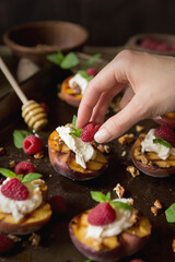 Dark mood grilled summer peaches with cream, raspberries & honey