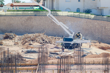 Concrete pump truck with concrete mixer at a construction site