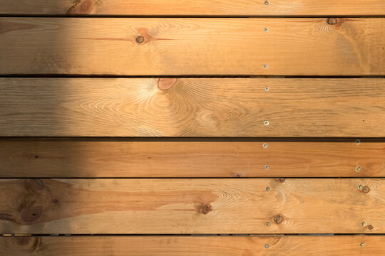 The background cladding is made of light wood planks.