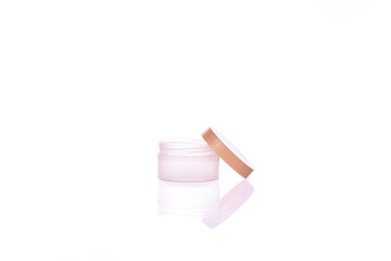blank packaging clear cosmetic cream pot reflected in glass surface isolated on white background ready for product design. Skin care, pure beauty, body treatment concept.