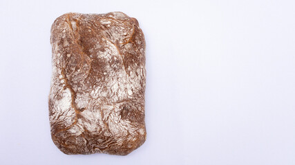 Black bread on the white background, top view